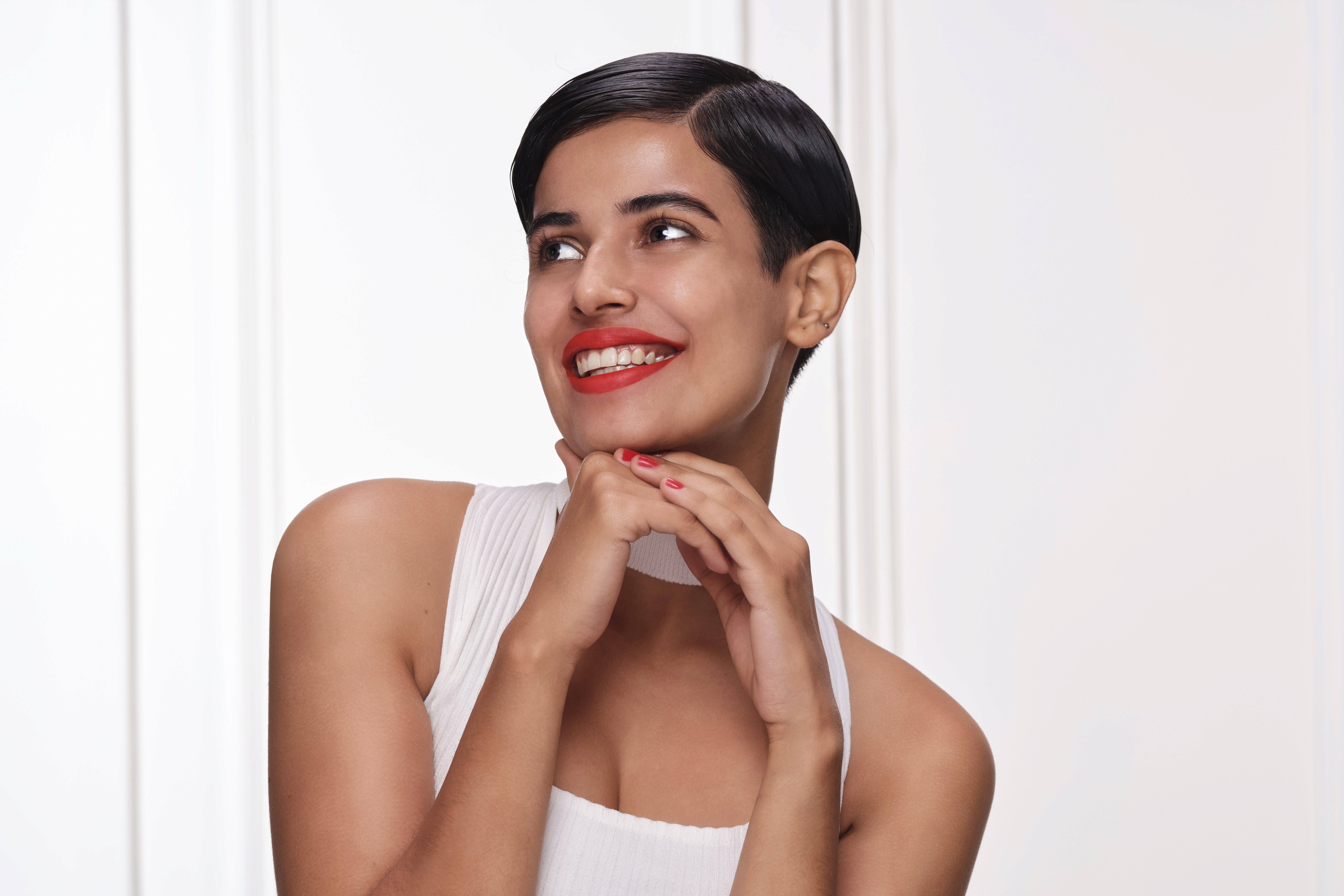 Group of friends smiling on a lively city street at night