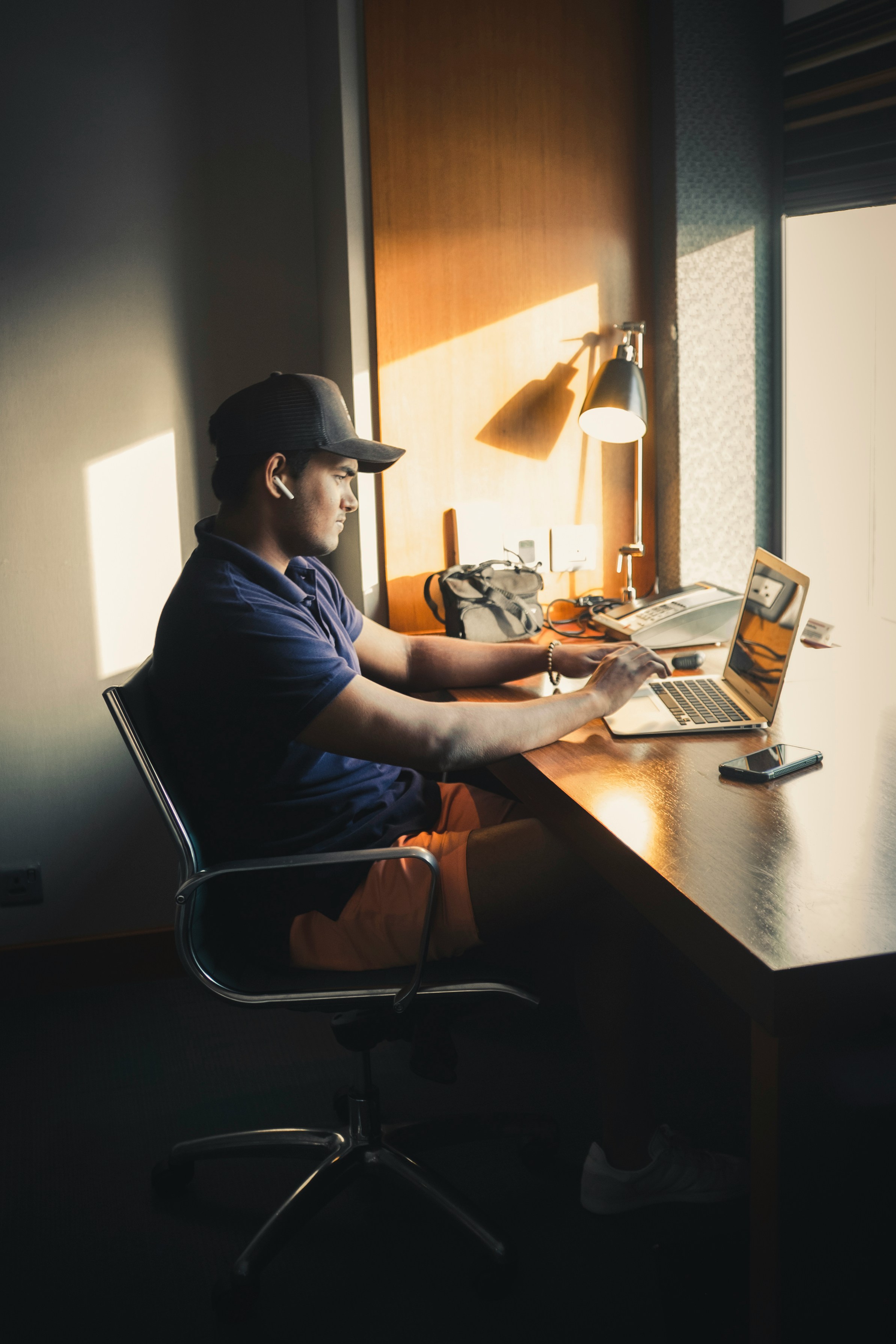 man in blue shirt sitting on chair in front of table