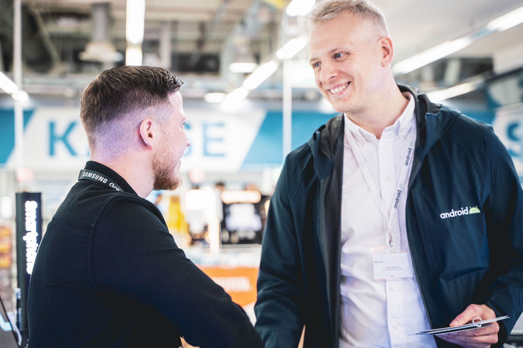 Zwei Männer im freundlichen Gespräch in einer modernen Verkaufsumgebung. Steht für kompetente Beratung, Kundenorientierung und partnerschaftliche Zusammenarbeit.