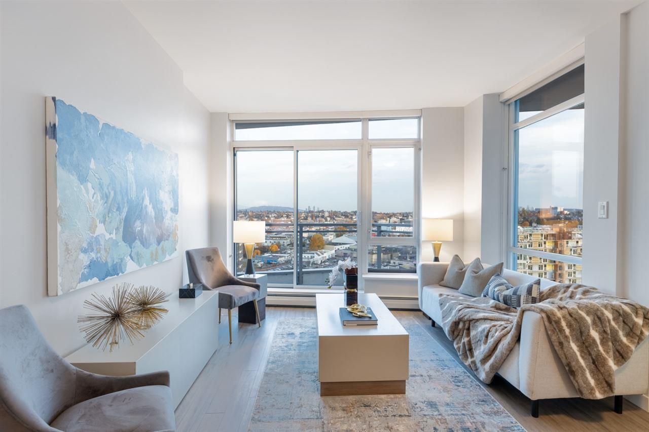 Bright and modern living room with large windows, comfortable seating, and a stylish coffee table.