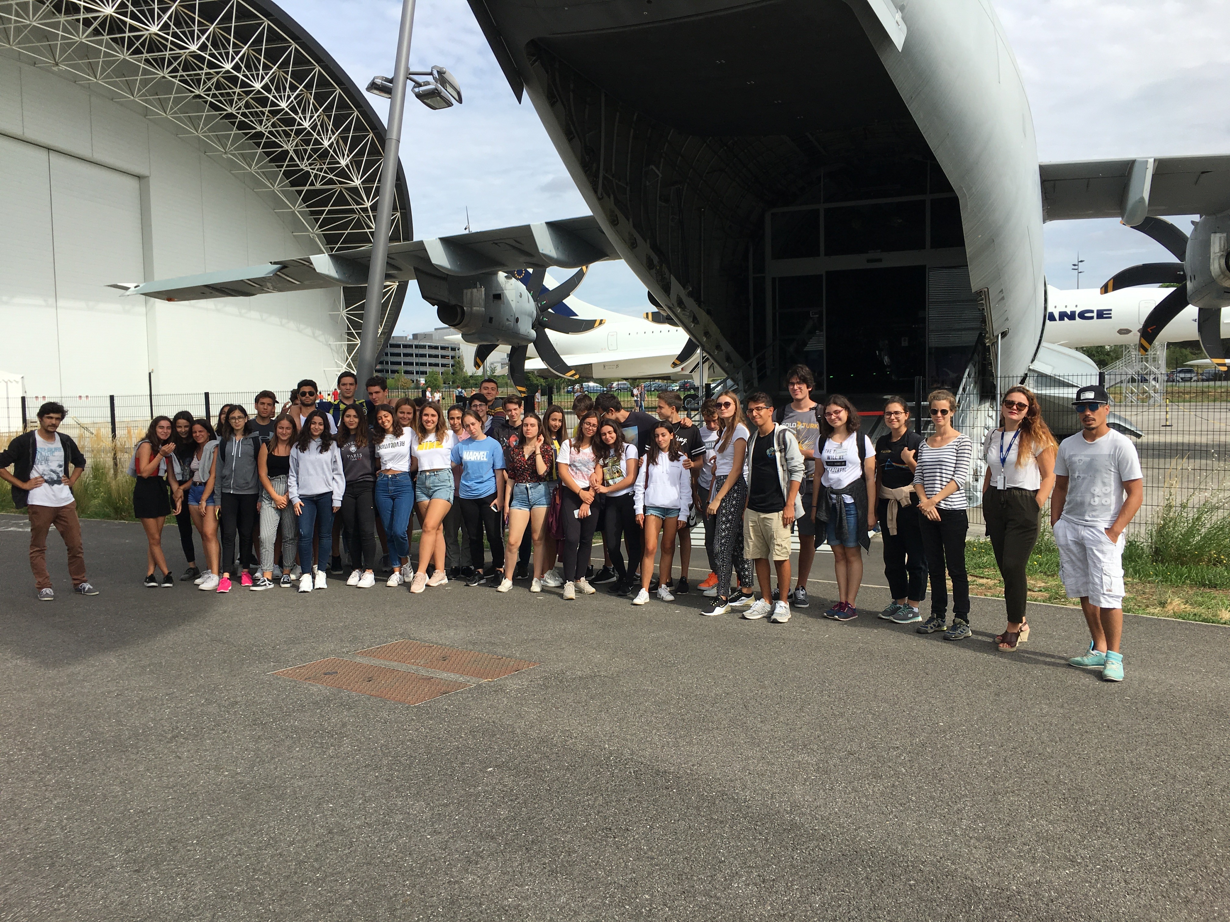 man in blue crew neck shirt wearing black framed eyeglasses holding green ceramic mug