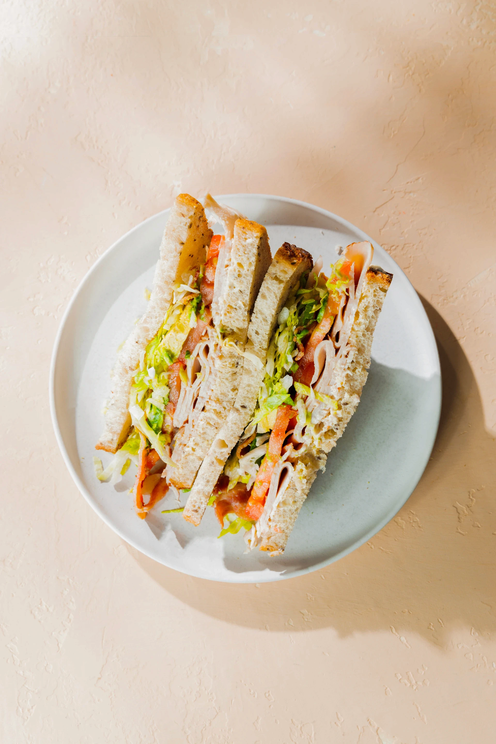 Top view of a sandwich on a white plate.