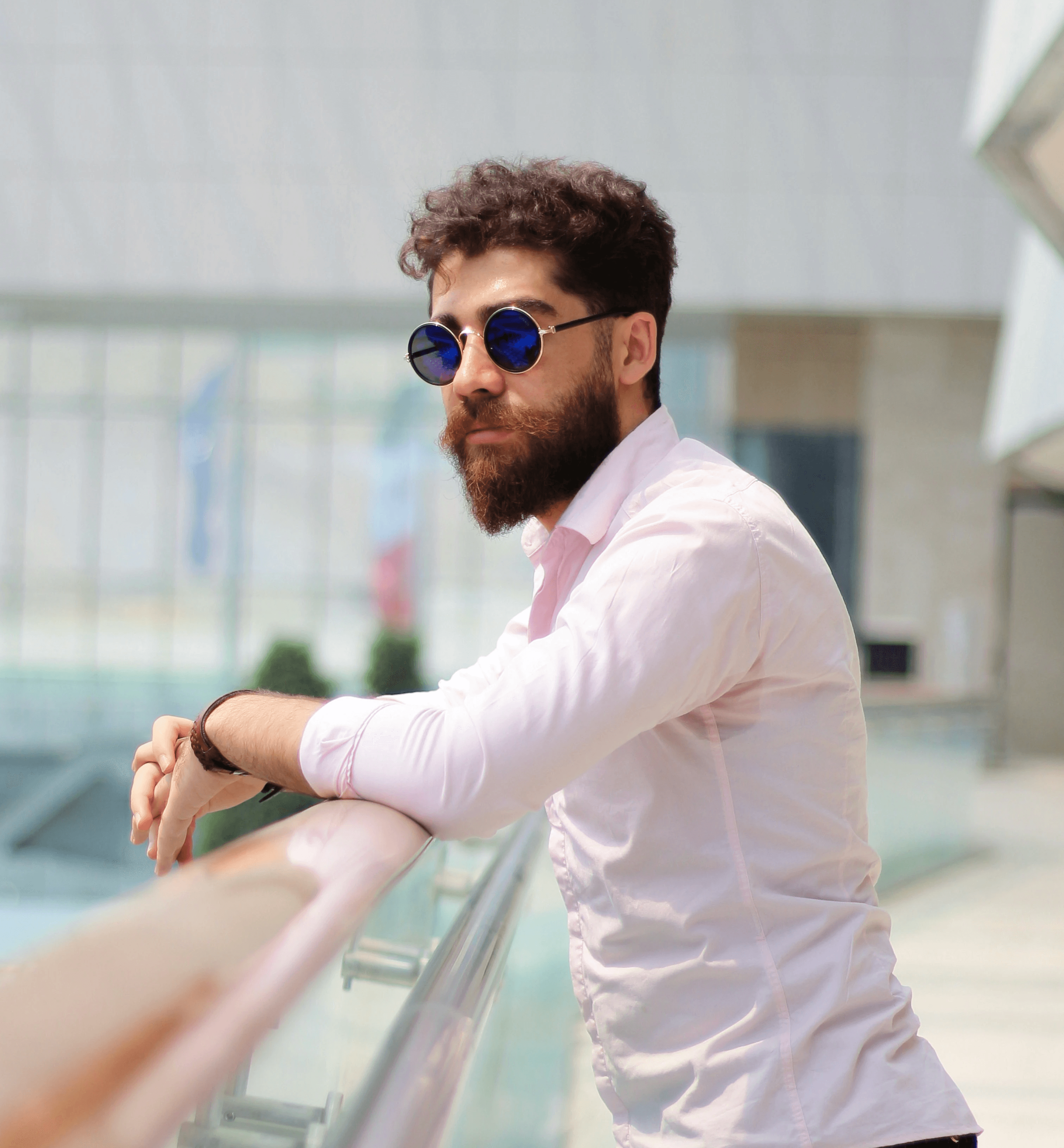 man in white dress shirt and black pants wearing black sunglasses standing on escalator
