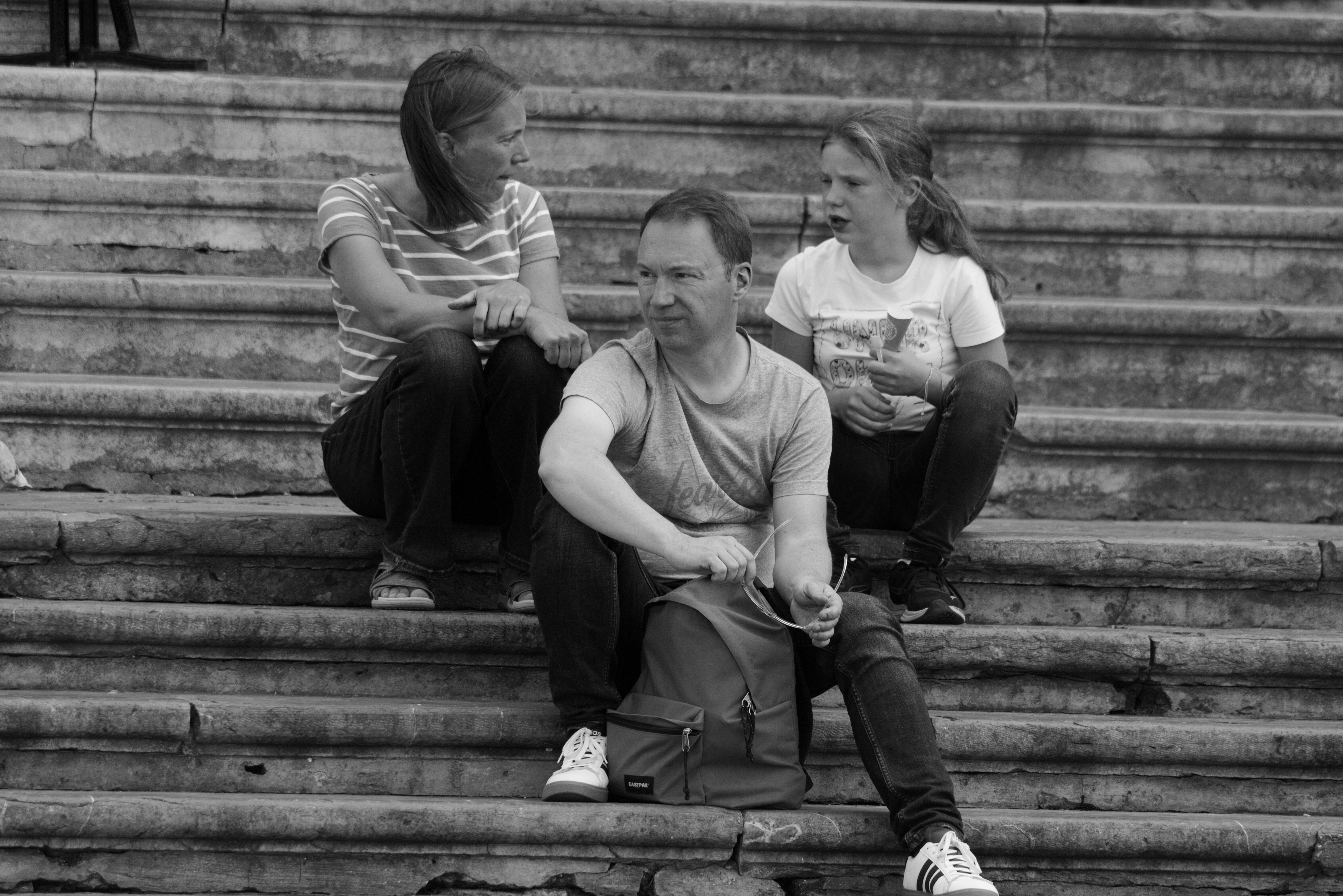A group of people sitting on the steps of a building