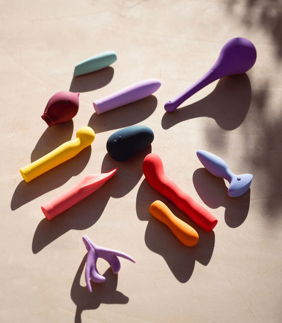 A cozy room with a wooden desk, computer, and warm sunlight streaming through a window.