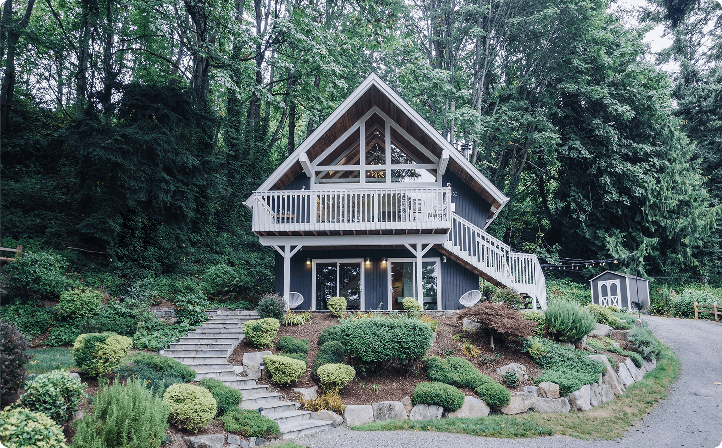 Elegant farmhouse bathroom featuring white marble countertops, vessel sink, chrome sconces, and white shiplap walls