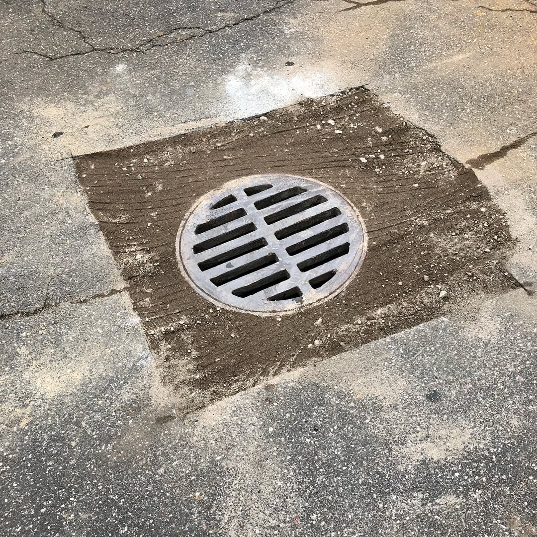 Catch basin and storm drain in a Long Island parking lot