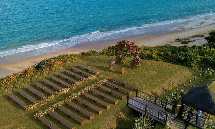 A beautifully set dining table with white tablecloth, cutlery, and fresh greenery in a cozy, well-lit space.