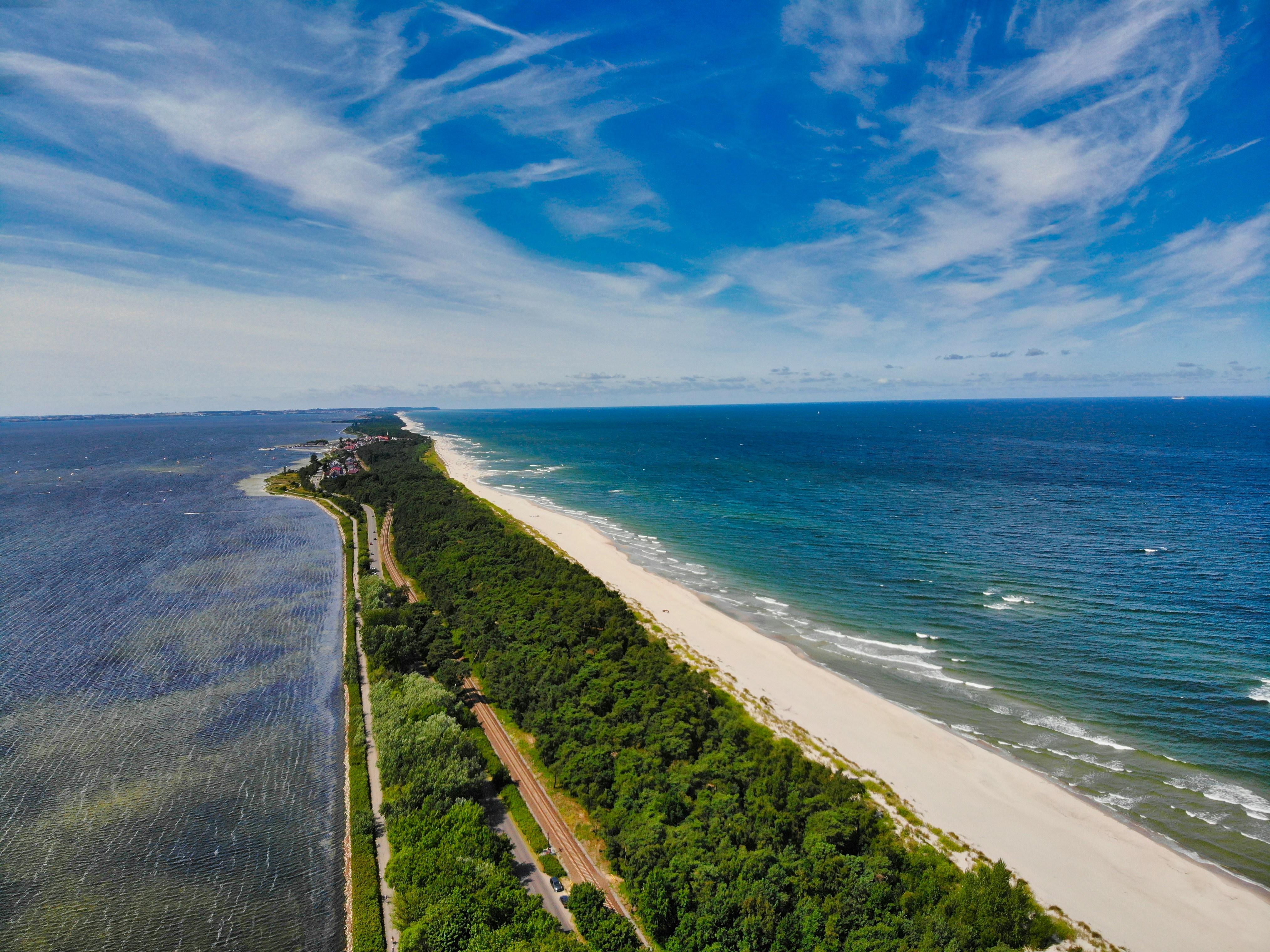 an aerial view of a long stretch of beach next to the ocean