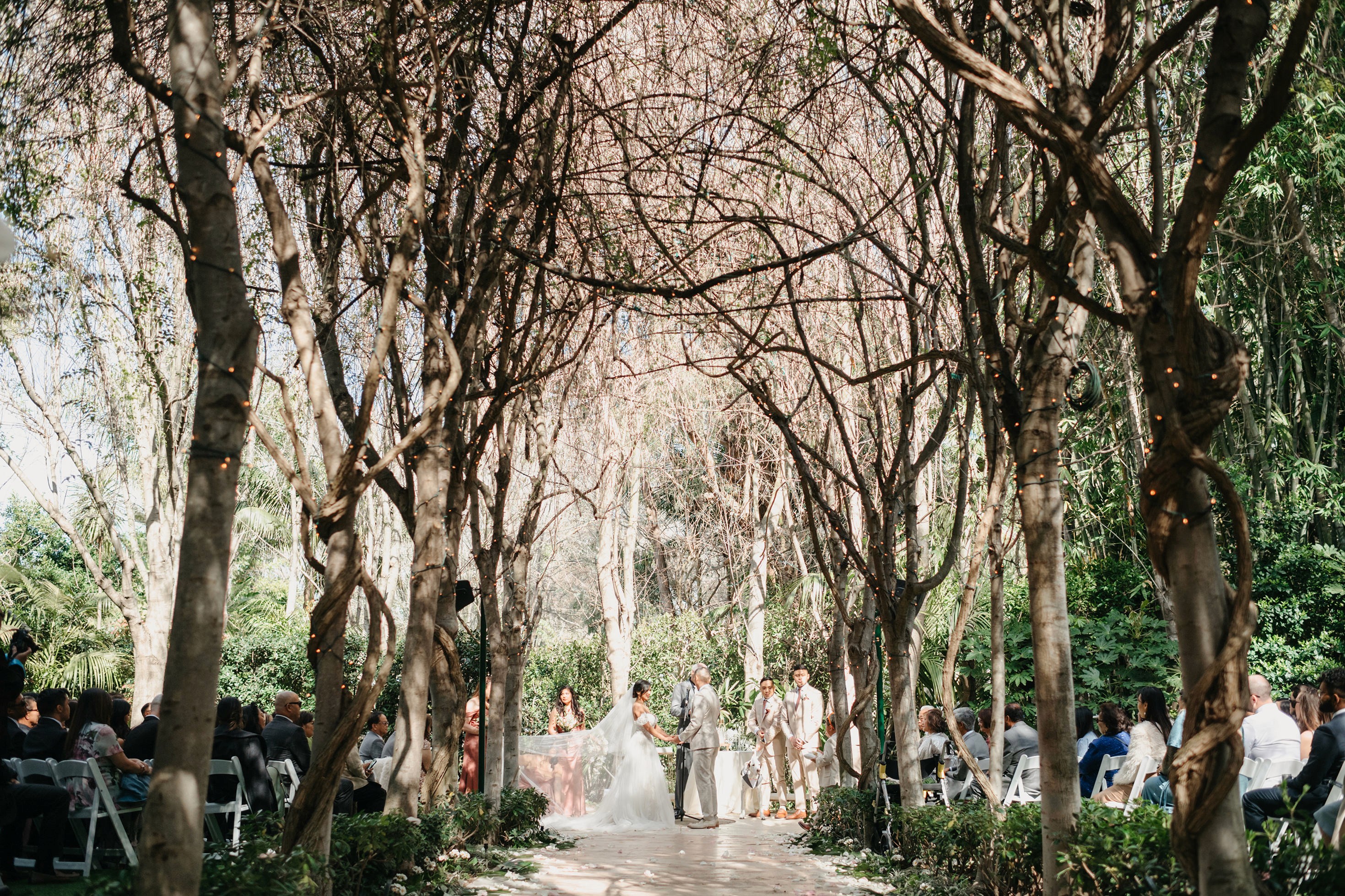 Flat lay wedding details with bouquet, rings, and sparkling bridal heels