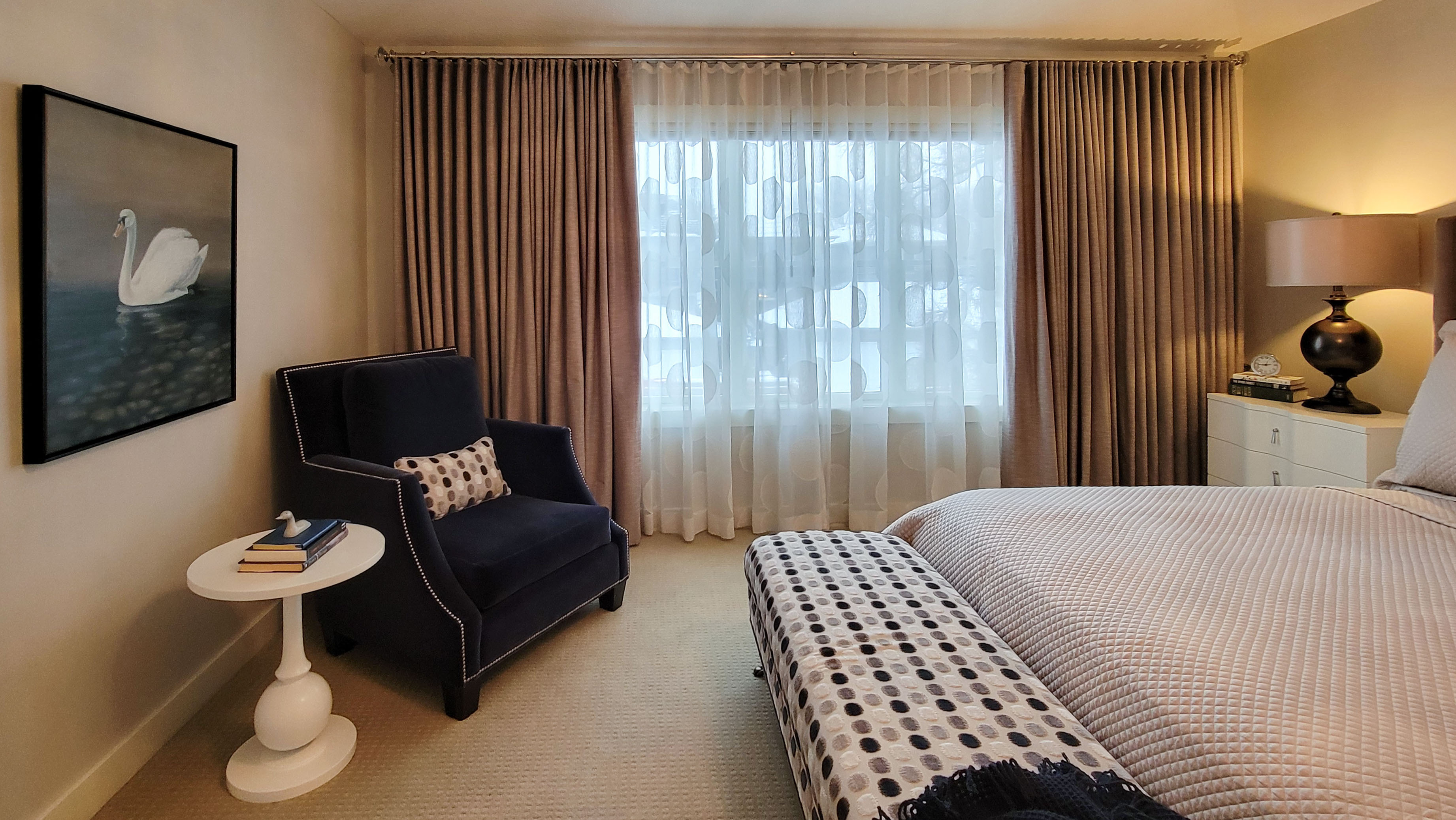 Image of Luxurious primary suite with plush furniture, window coverings, and design elements by KHD Homes.