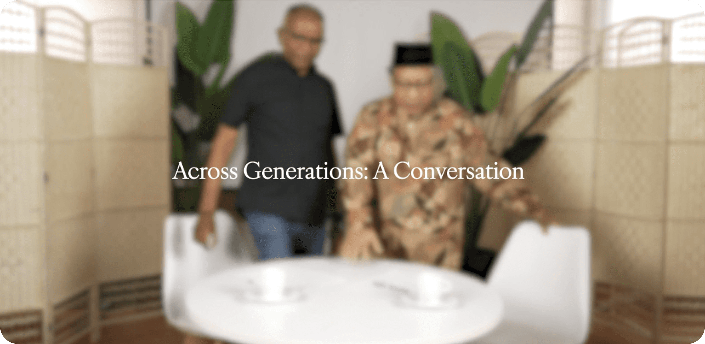 A paper coffee cup with a brown lid features a warm-toned abstract design resembling mountains. It conveys a cozy and earthy tone against a beige background.