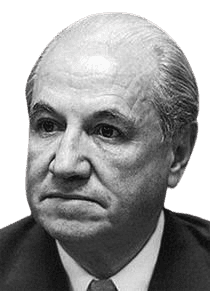 A black-and-white portrait of an older man with a serious, contemplative expression, dressed in a suit and tie. His slicked-back hair and focused gaze convey a sense of authority and professionalism, suggesting he may be a prominent figure in politics, business, or academia.