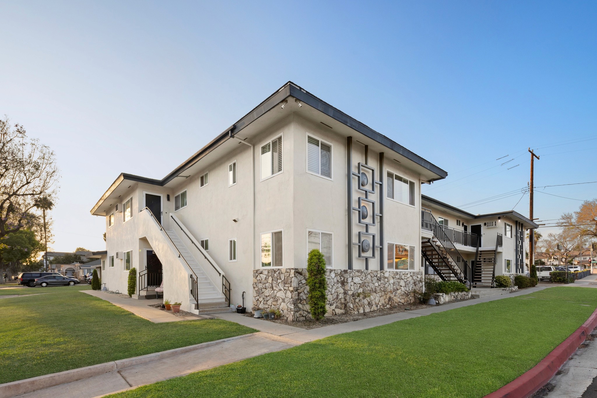 9025 Mills Avenue exterior view showing updated two story apartment building with stone accents