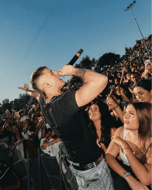 Music artist performing on stage in front of a crowd