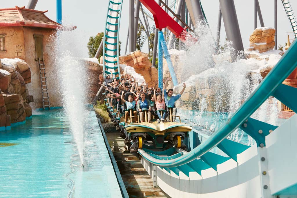 Riders on a water coaster splashing down at PortAventura Park