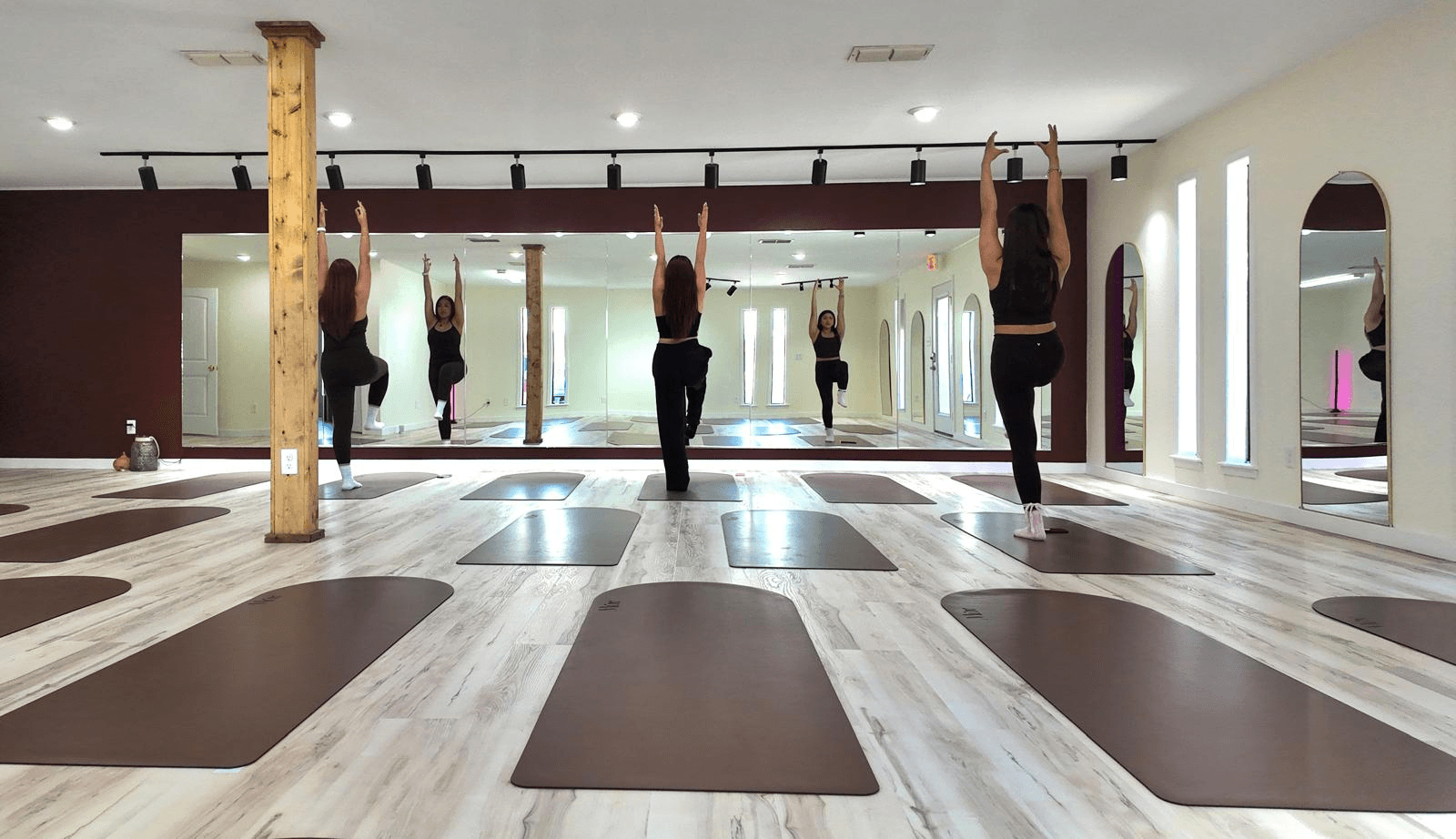 A serene spa setting with two lounge chairs beside a warm, reflective pool and soft, natural lighting.