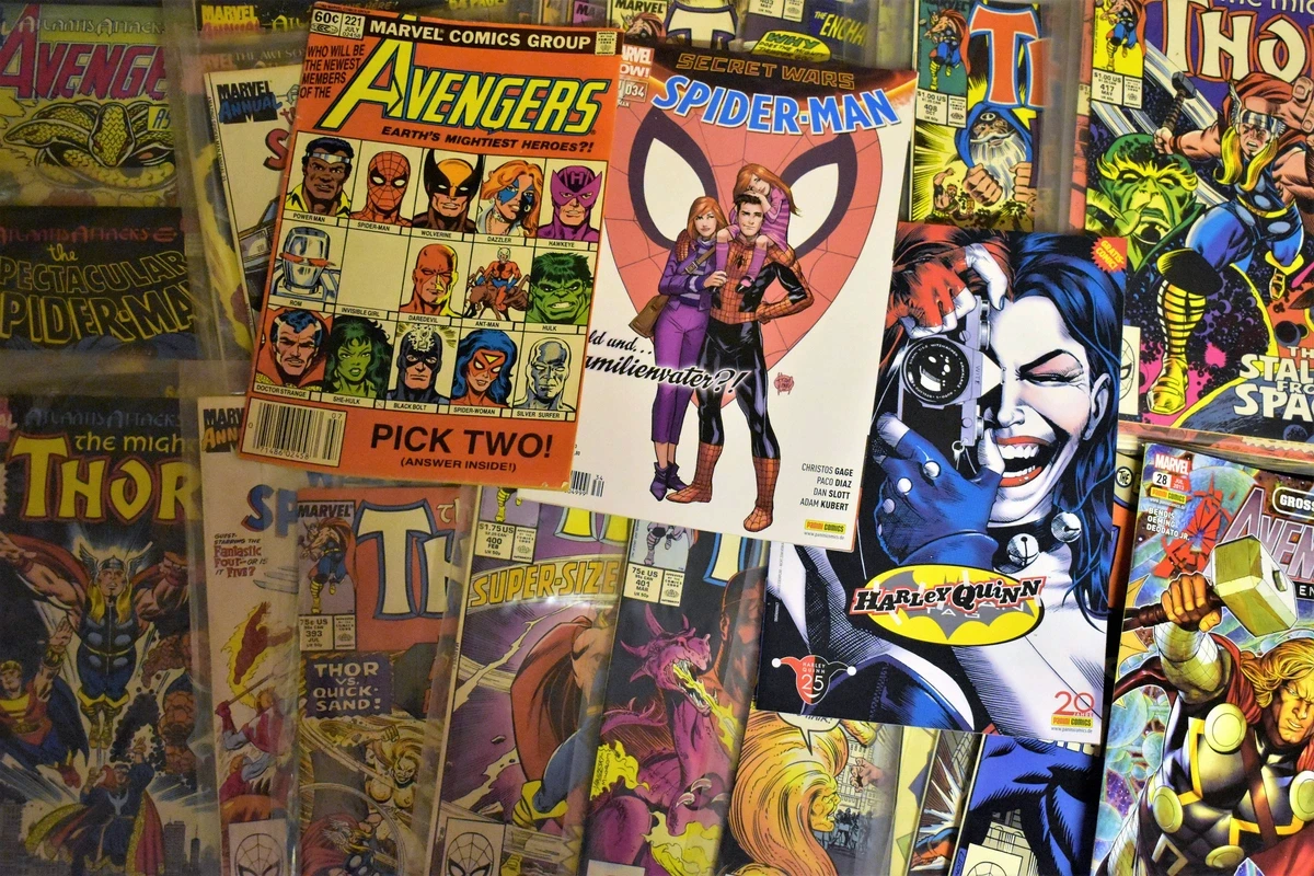 Collection of Marvel and DC comic books featuring Spider-Man, Avengers, and other superhero characters, representing the intellectual property that drives Marvel Studios' investment value.