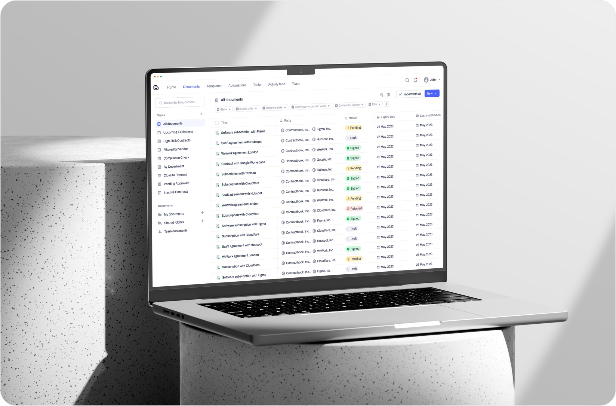 Laptop screen showing a contract management dashboard with document statuses.
