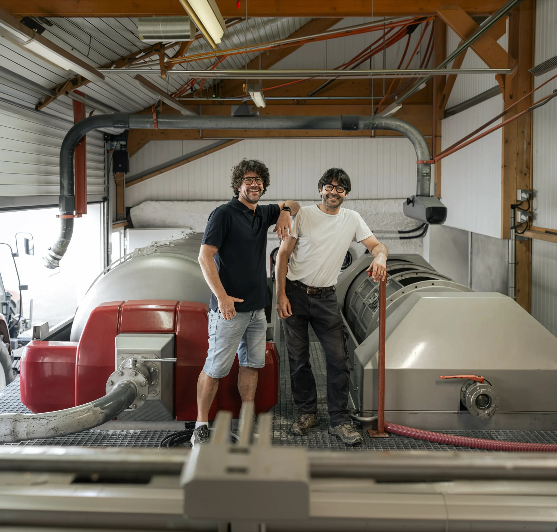 The estate's winemakers in front of the winery press