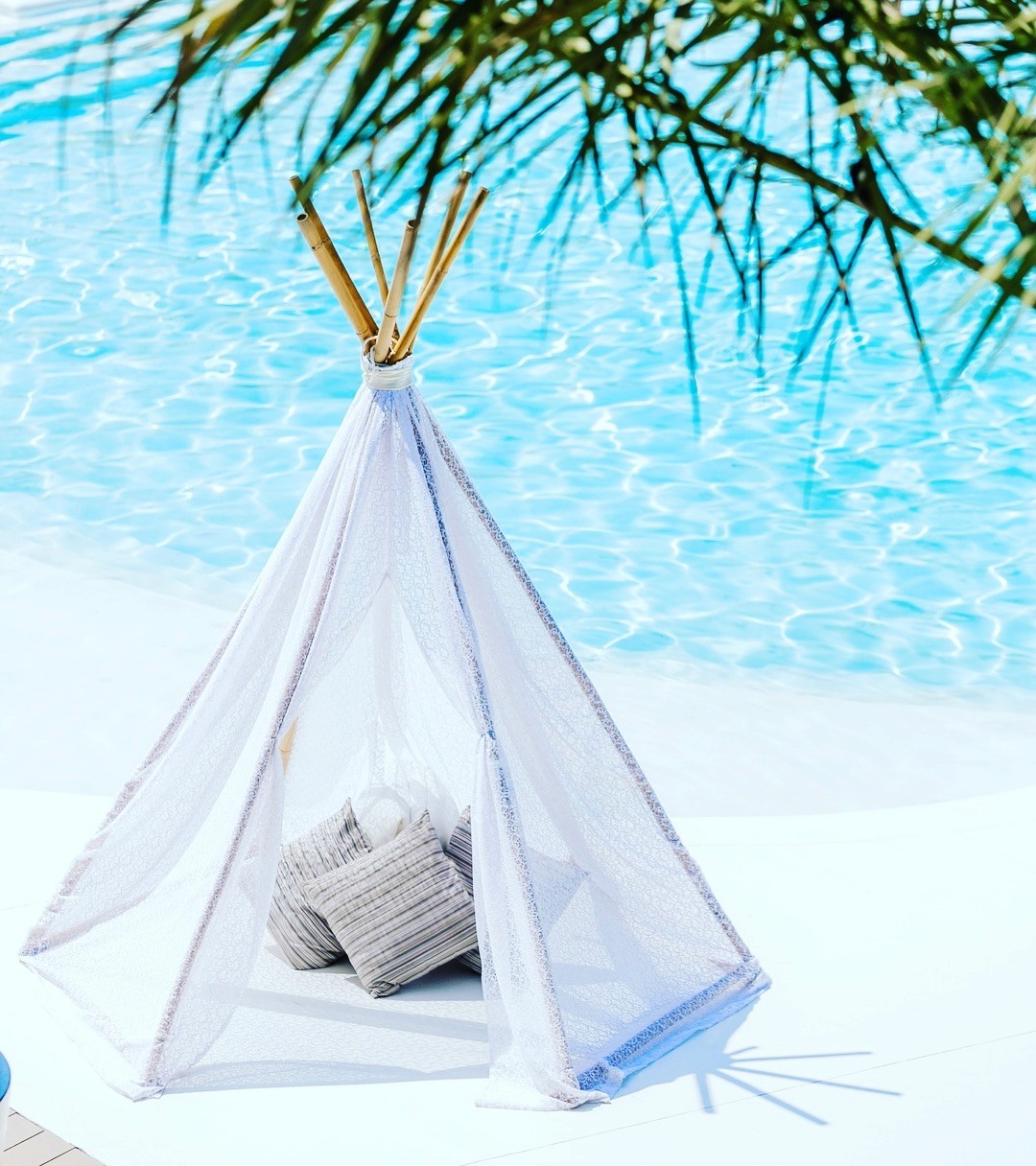 Black-and-white party photo of a smiling man in a check blazer among a crowd.