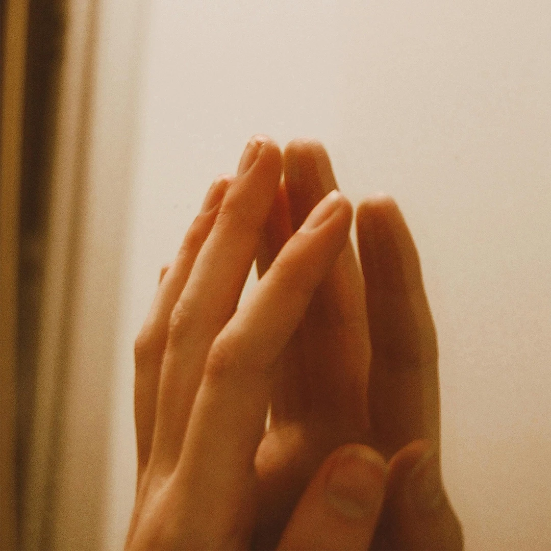 Close up of a woman with eyes closed practicing deep breathing