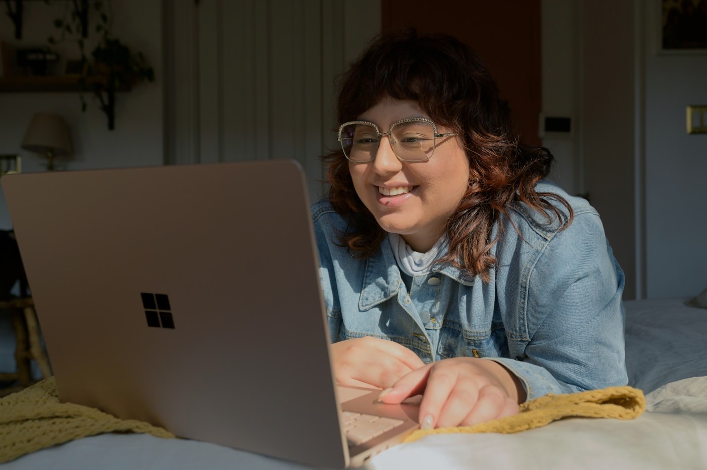 A woman at home checking her insurance coverage on a laptop before a telehealth nutrition visit