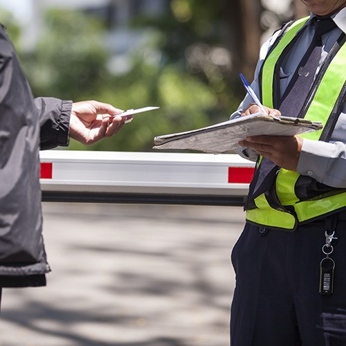 Security officier reviewing guest access to warehouse.