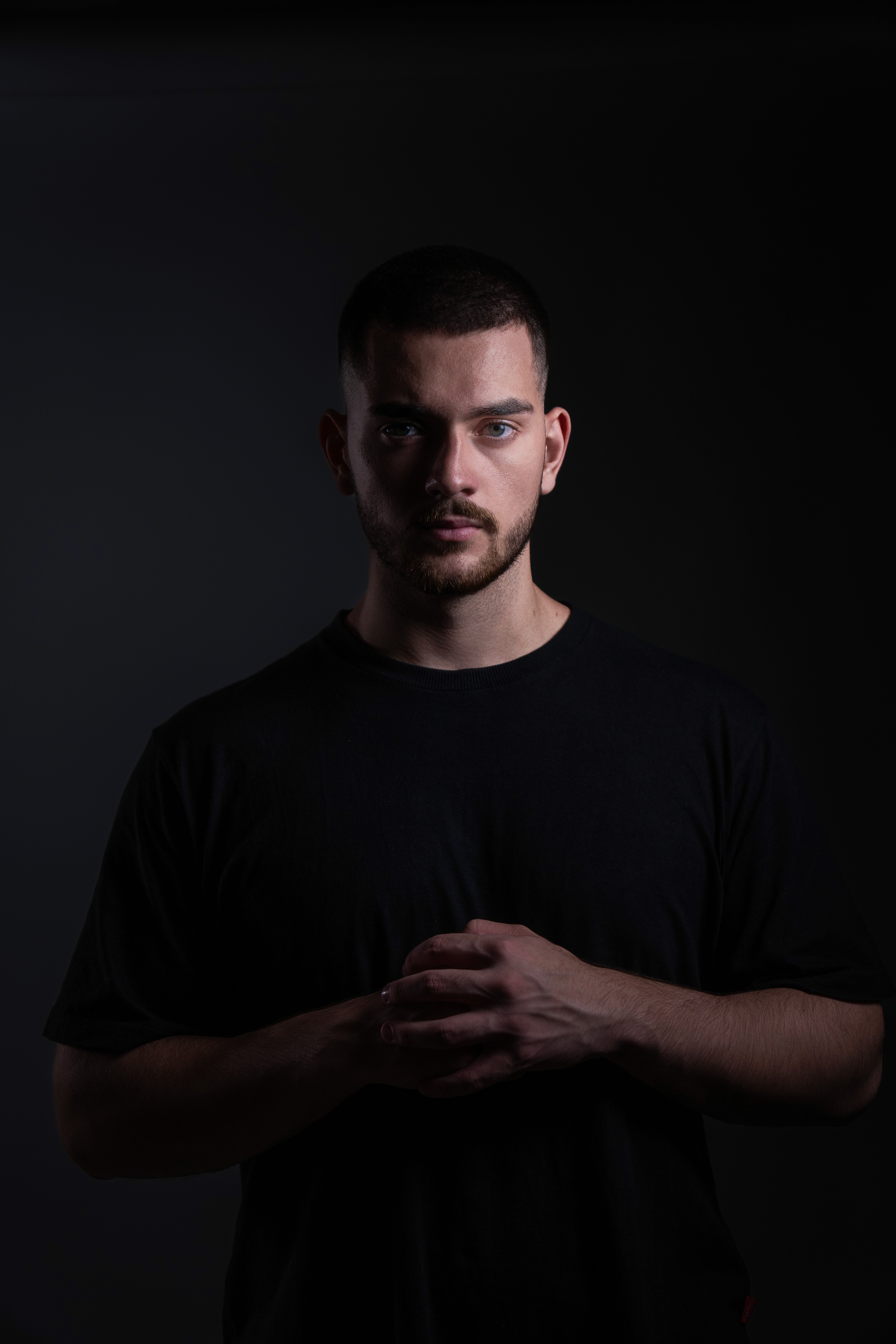 man wearing maroon V-neck t-shirt in forest