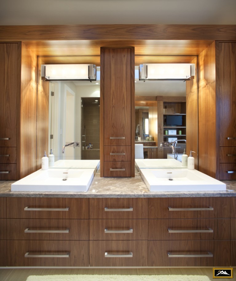 Image of Luxury bathroom design with double vanity, marble countertop, wooden cabinets, and large mirrors by KHD Homes.