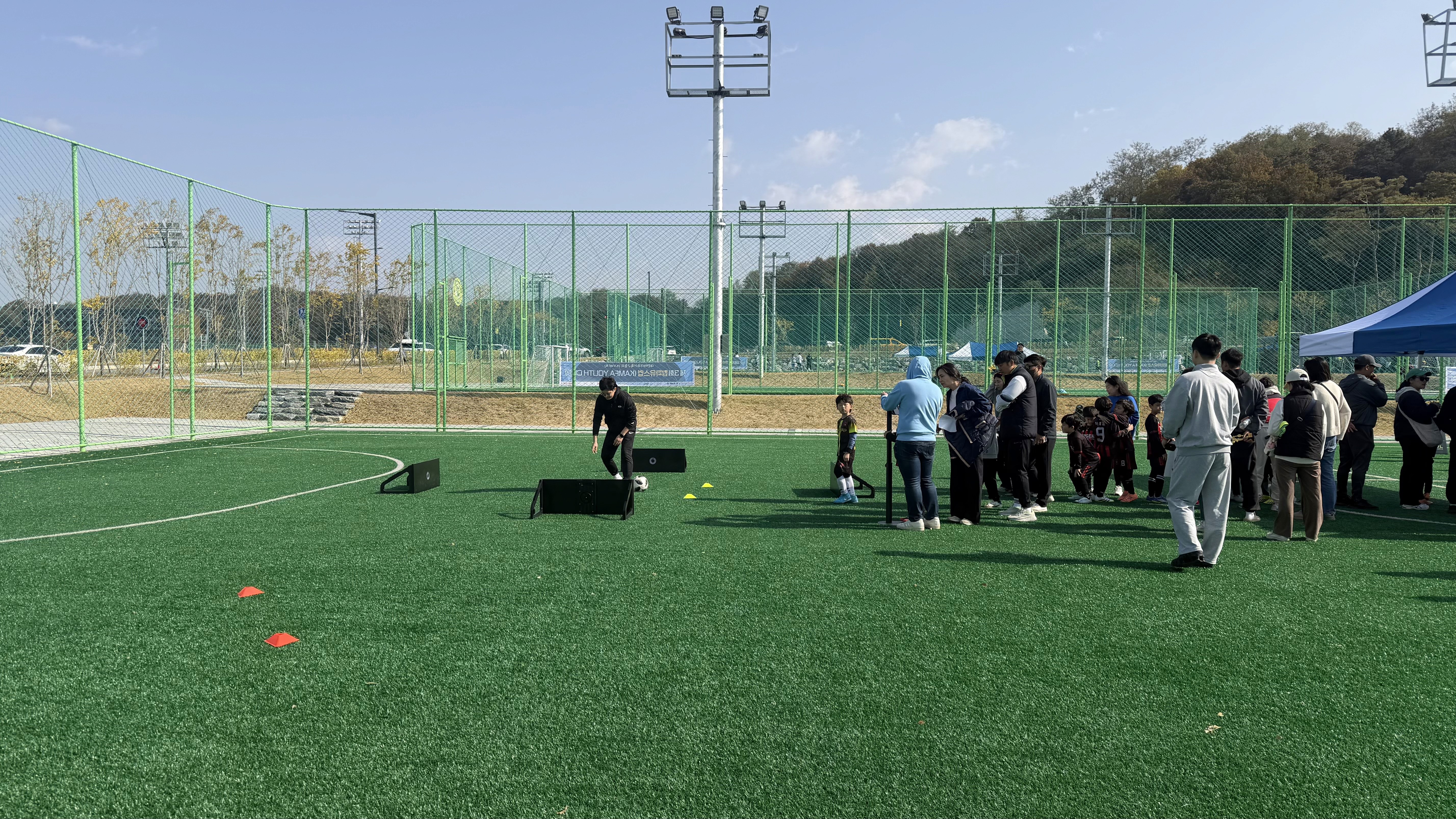 a person's feet with a ball on a purple carpet