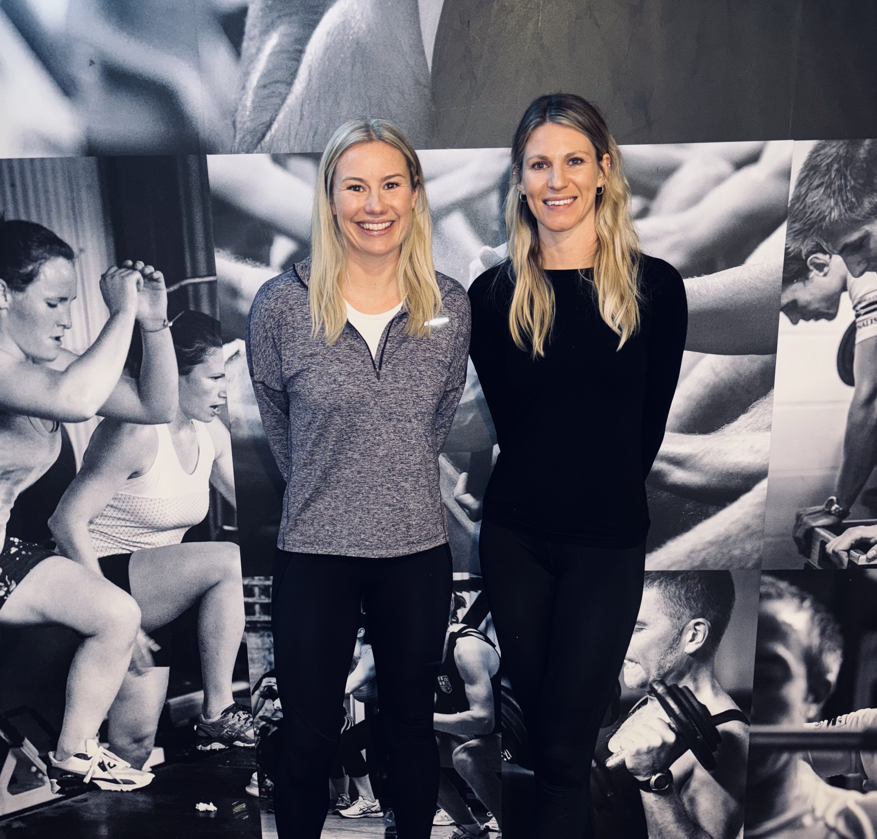 Personal trainer helping antenatal client with workout