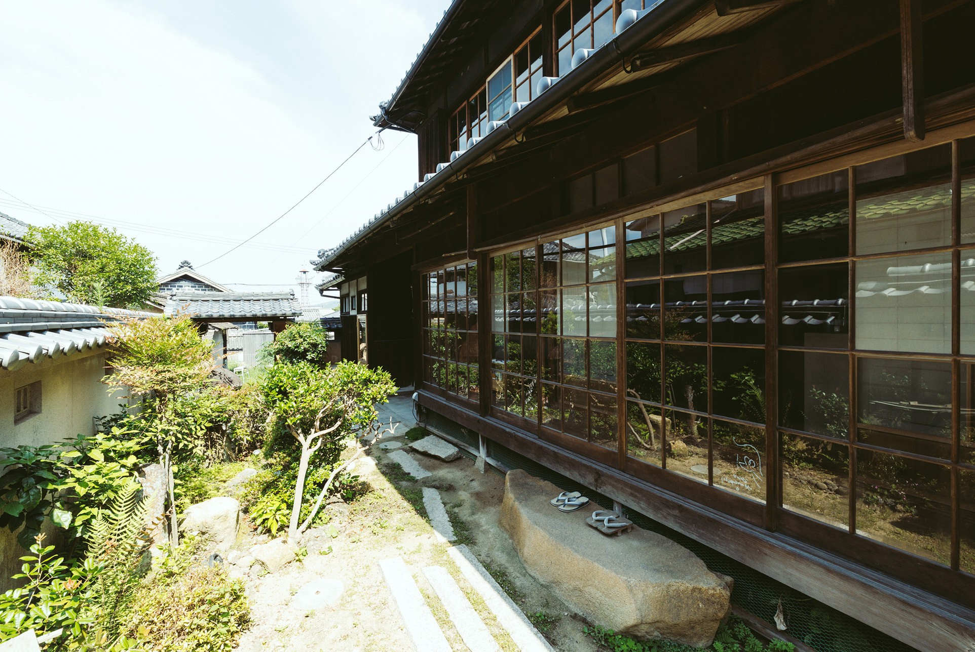 Exterior of the hotel with rocky shore at the forefront