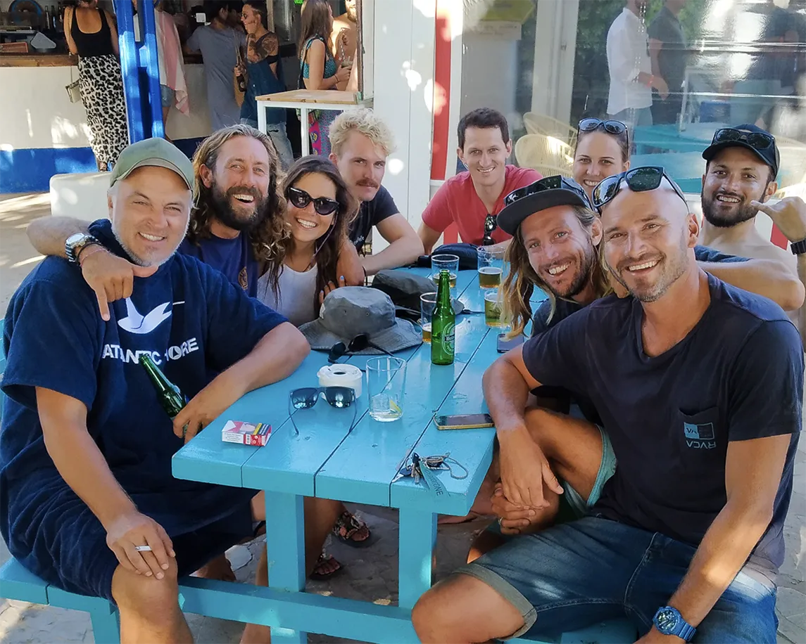Smiling watersports crew in Tarifa enjoying post-session vibes – Join us Today – Explora Watersports Tarifa