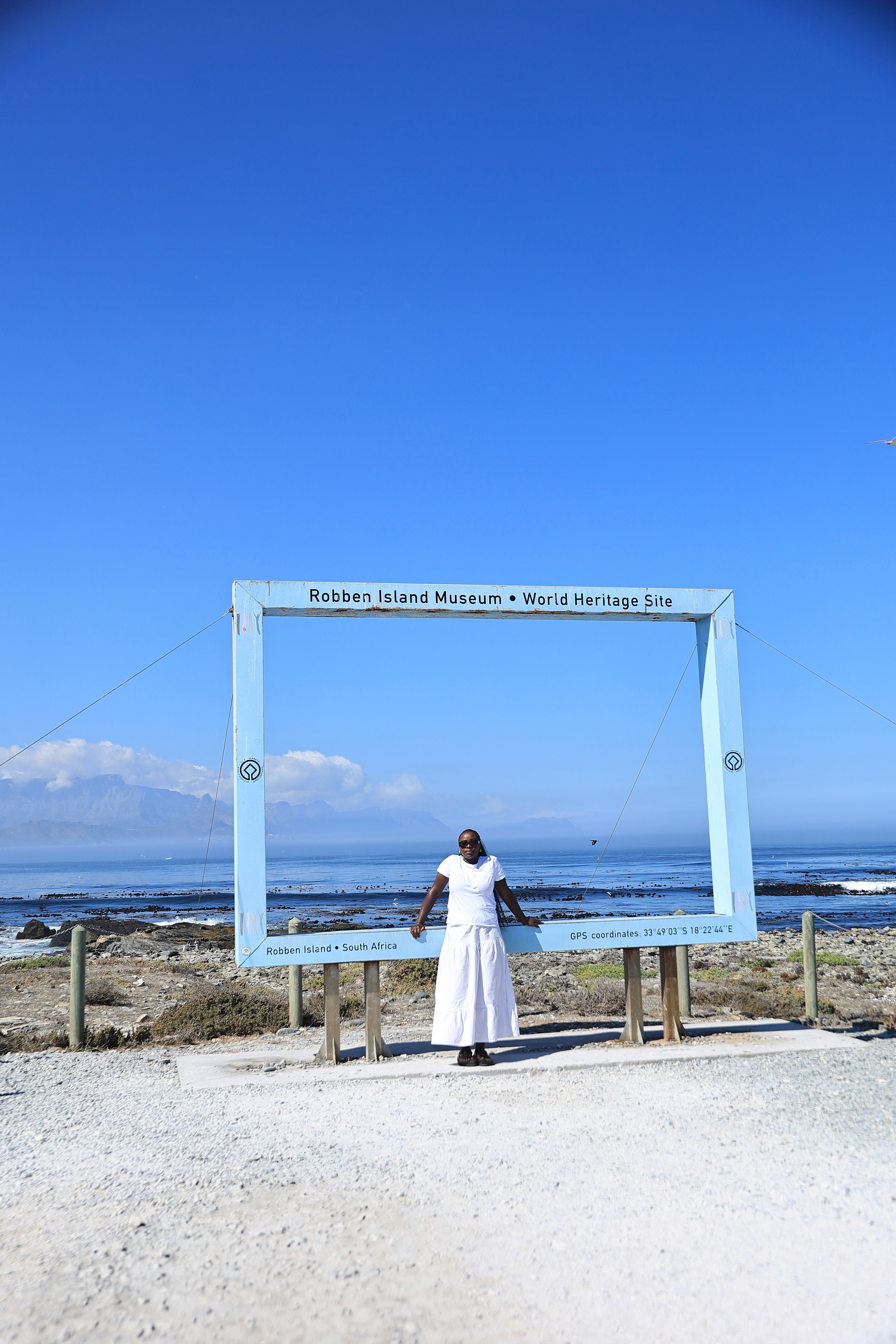 Mary Consolata Namagambe enjoying the sunshine and palm trees in a tropical location in Africa