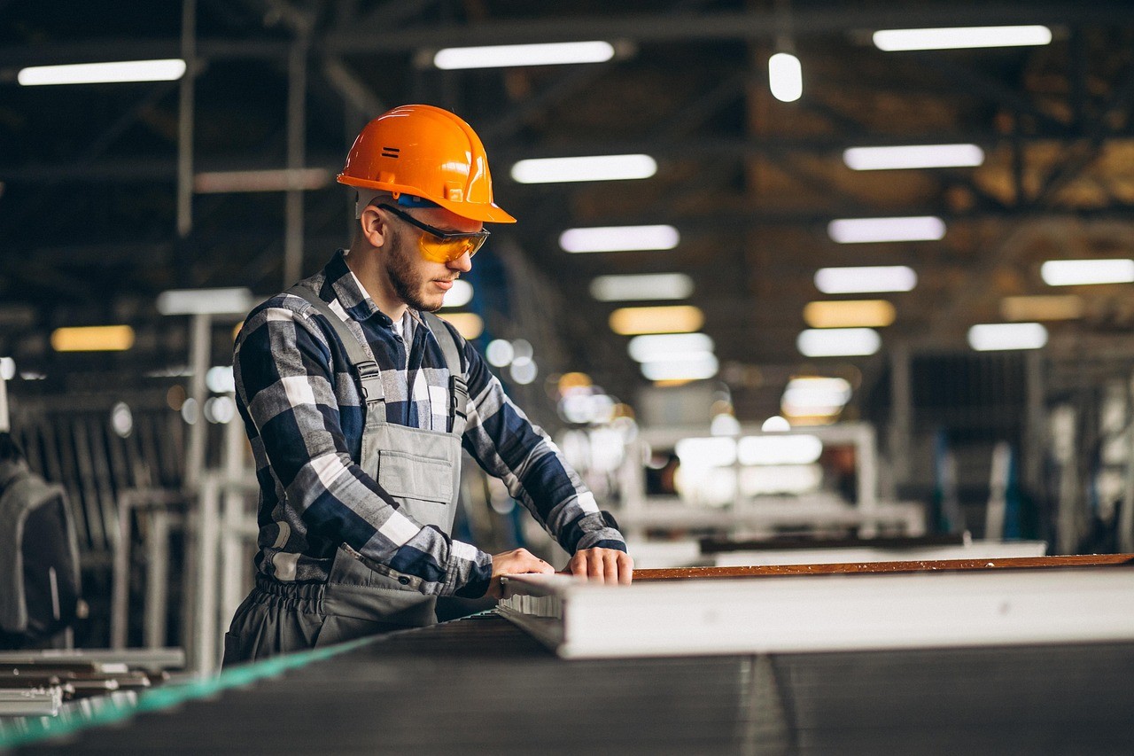 Industrial factory floor with machinery and yellow lines.