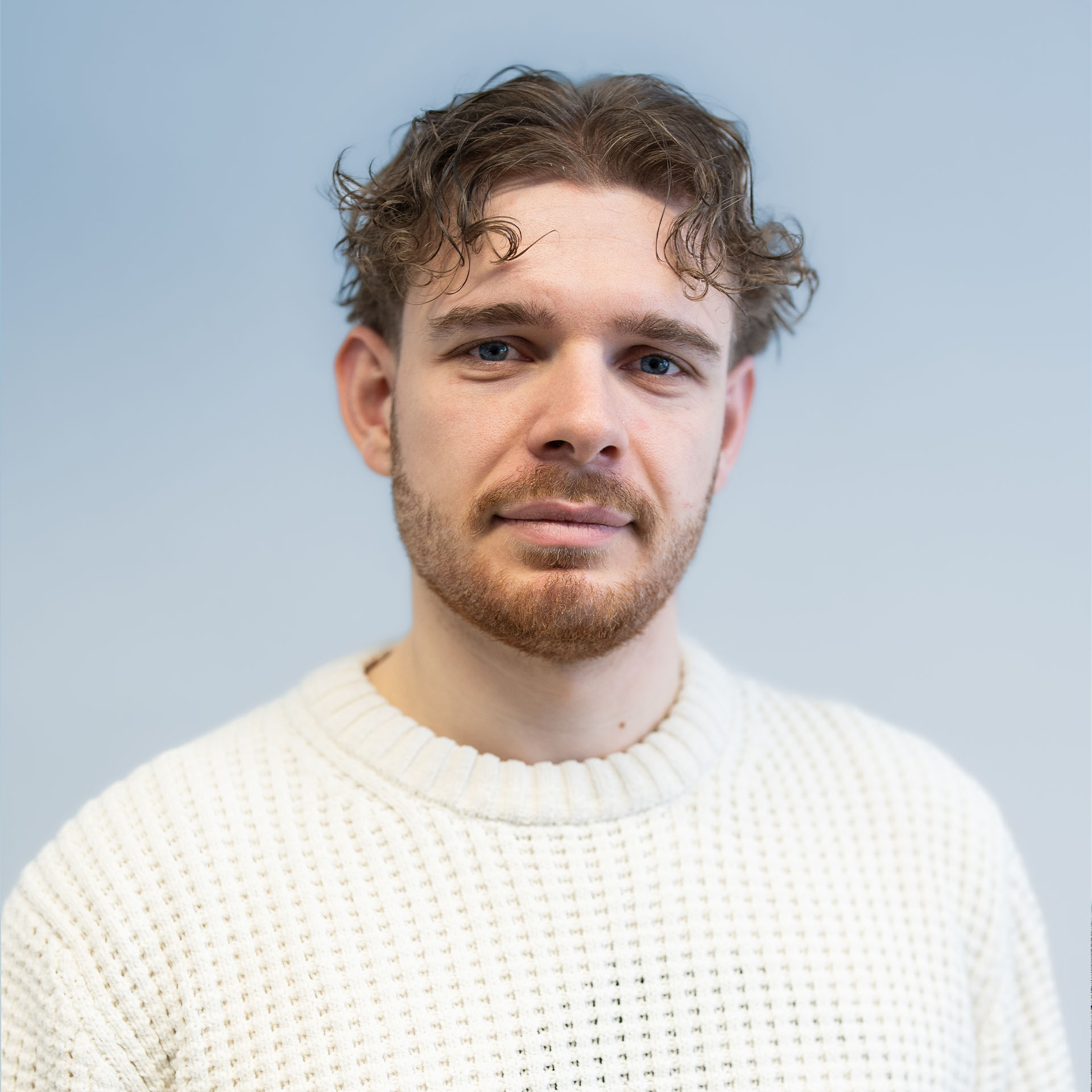 Portrait of a person in dark clothing speaking on a phone