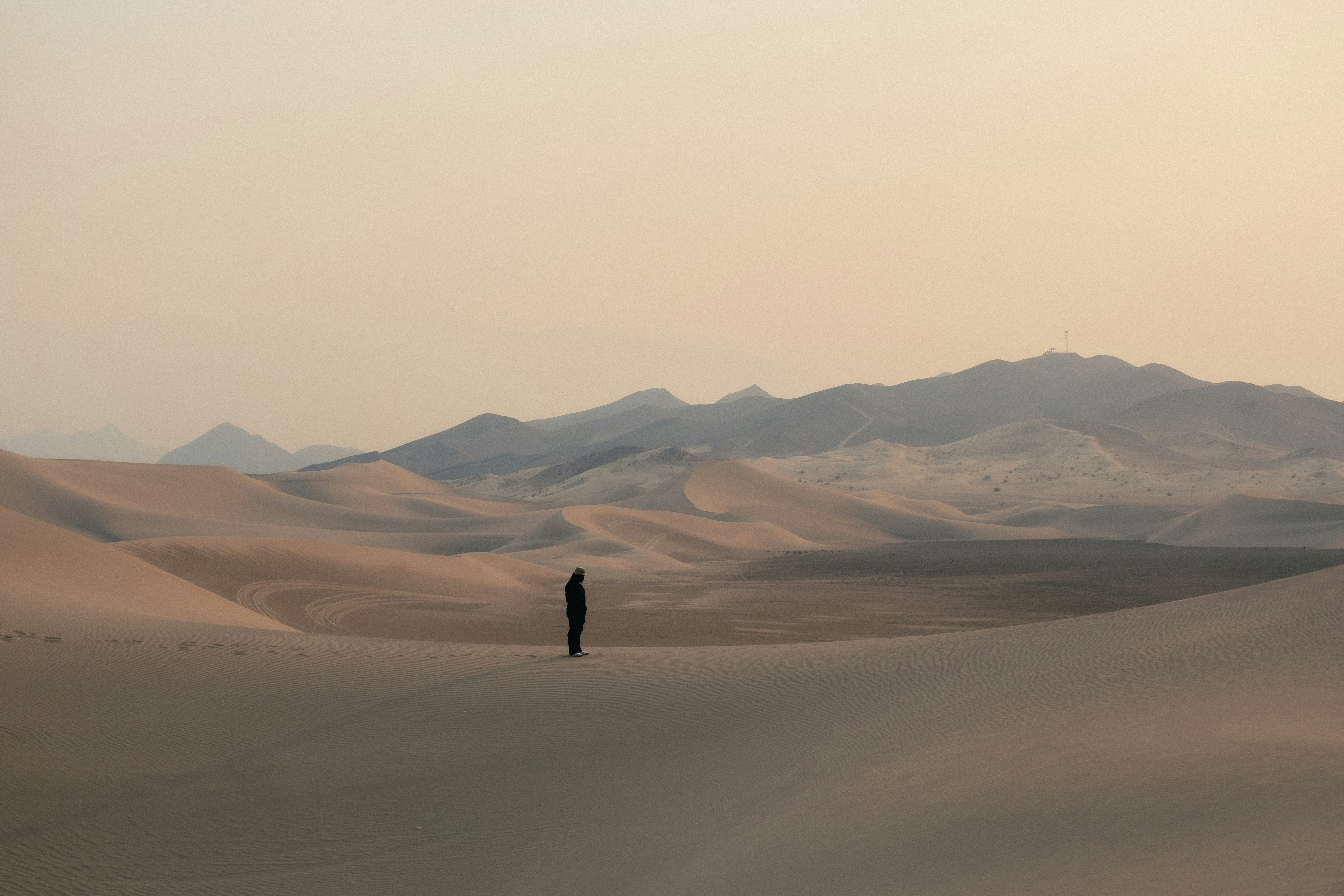 person walking on snow covered field during daytime
