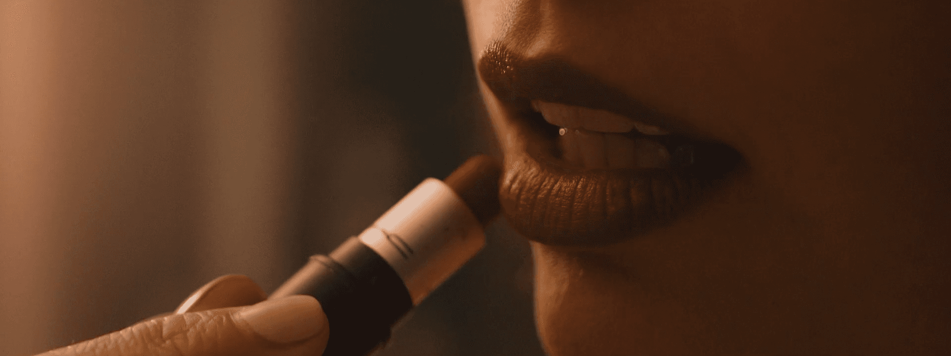 Silhouetted crowd observes pyramid through large windows.