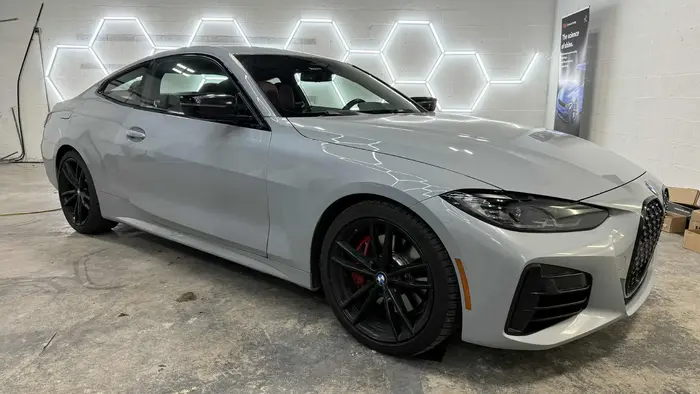 grey car in shop untinted window