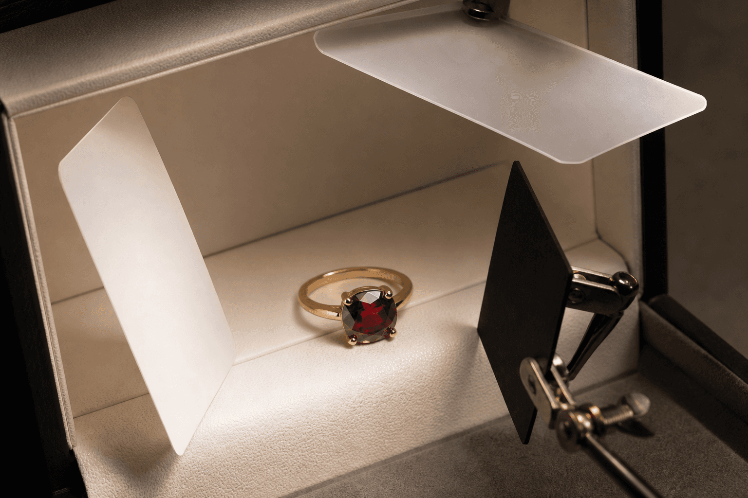 Conceptual jewelry light box with a ring, broad diffusion, one white card, and one black card