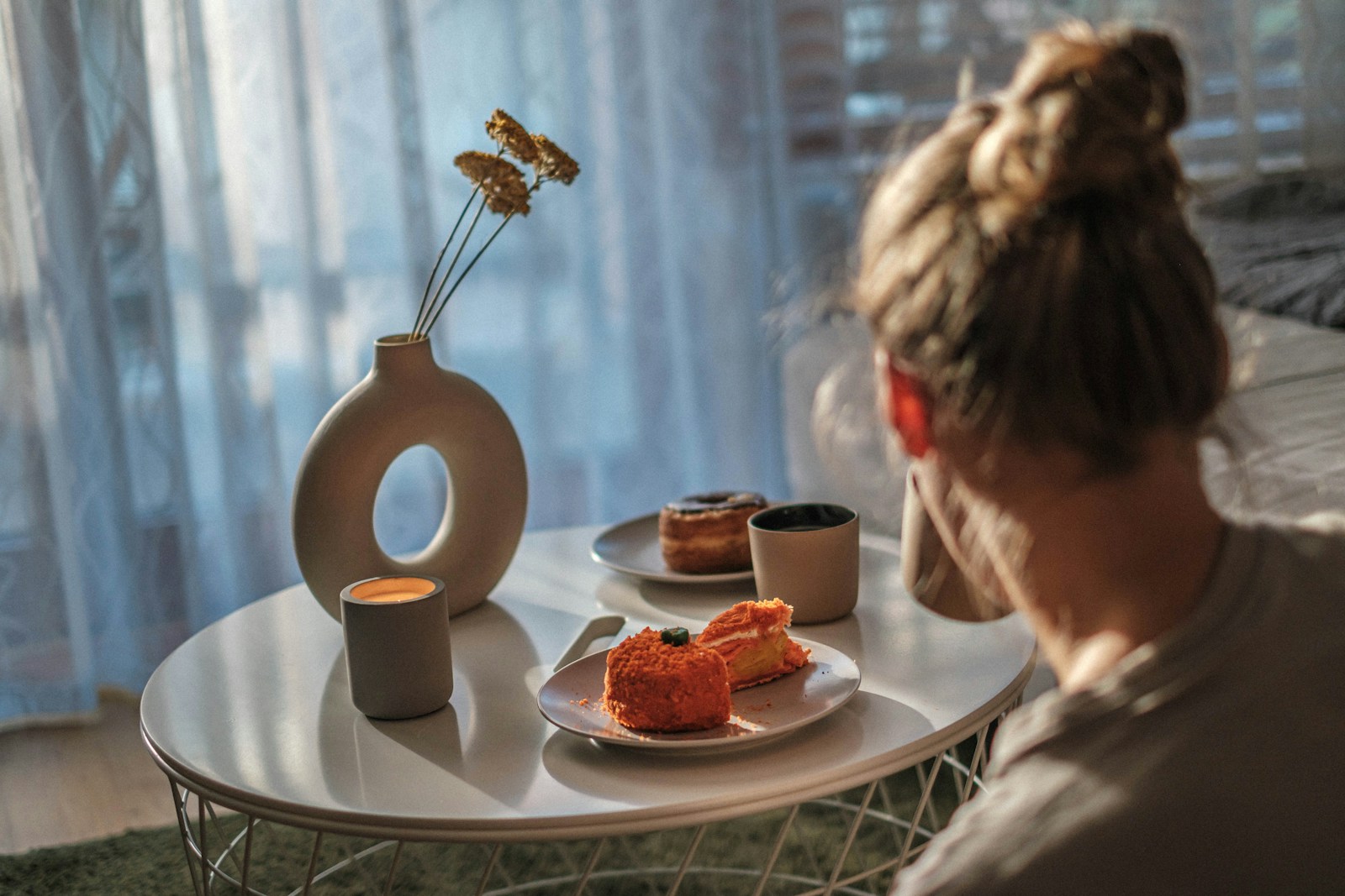 A person sitting down to eat a calm, regular meal at home, supporting steady eating patterns