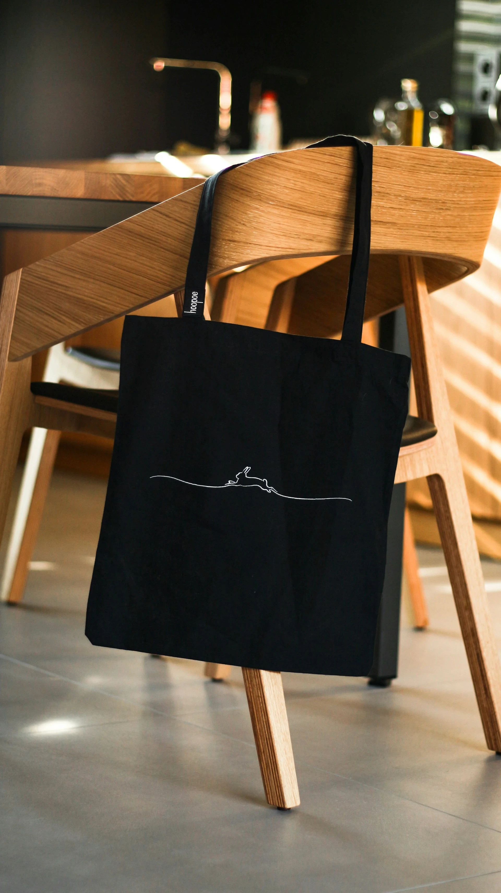 a black tote bag on a chair