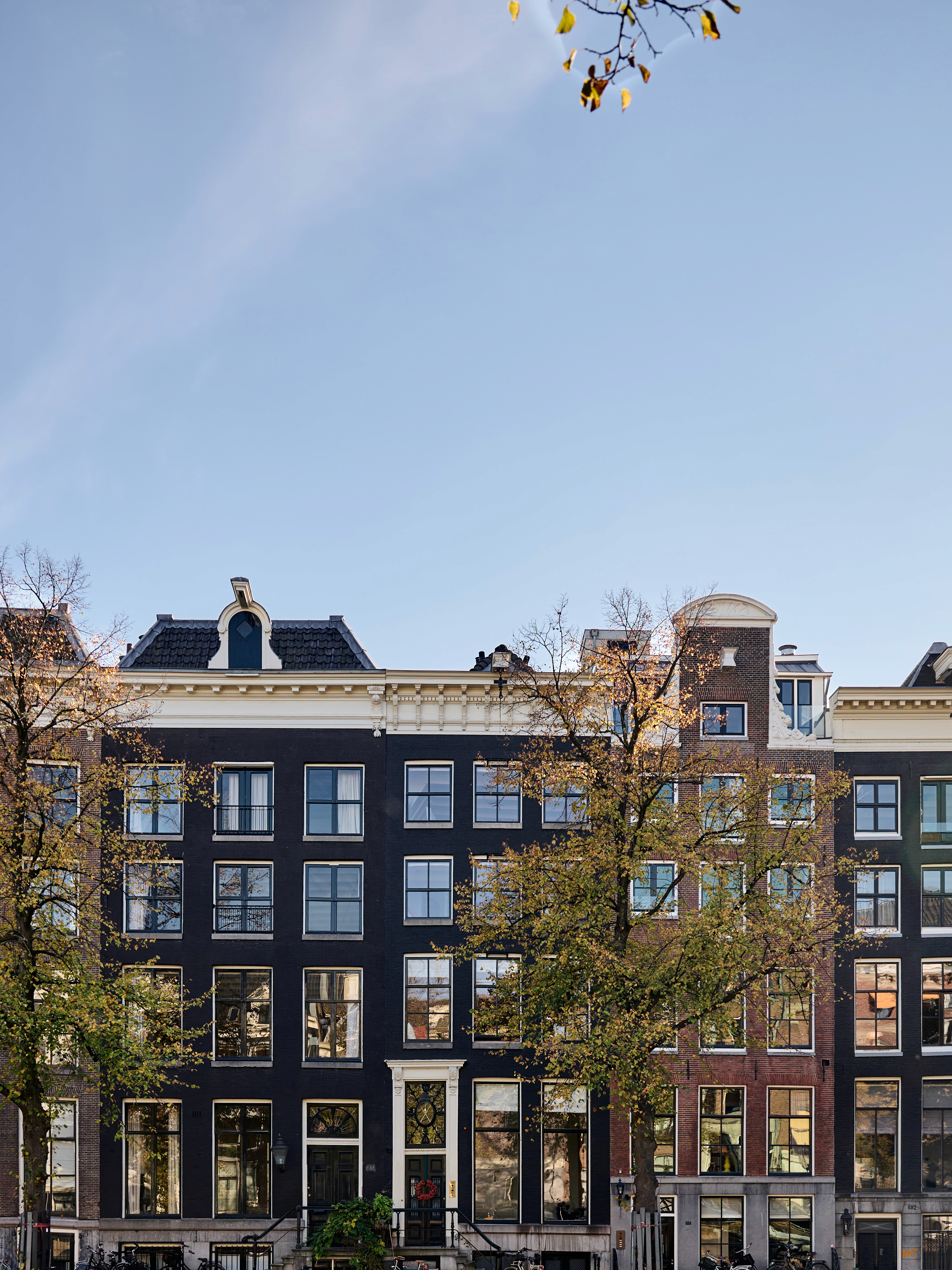 Modern interior entrance with floor-to-ceiling glass walls and warm timber cladding overlooking landscape