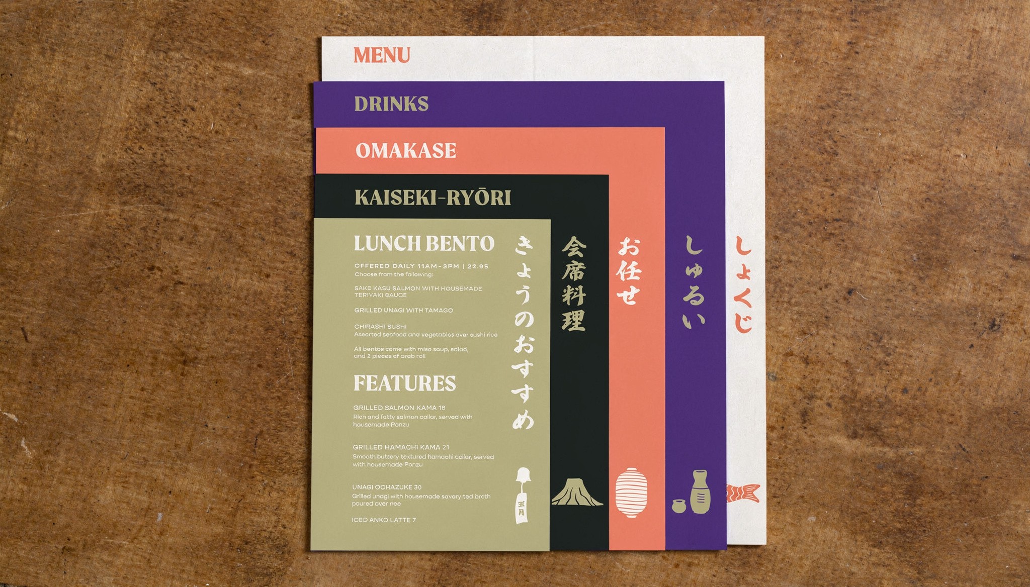 A beautiful, colorful 3 piece menu design for a Japanese restaurant, stacked on a midcentury table. The view is from directly above the menu's