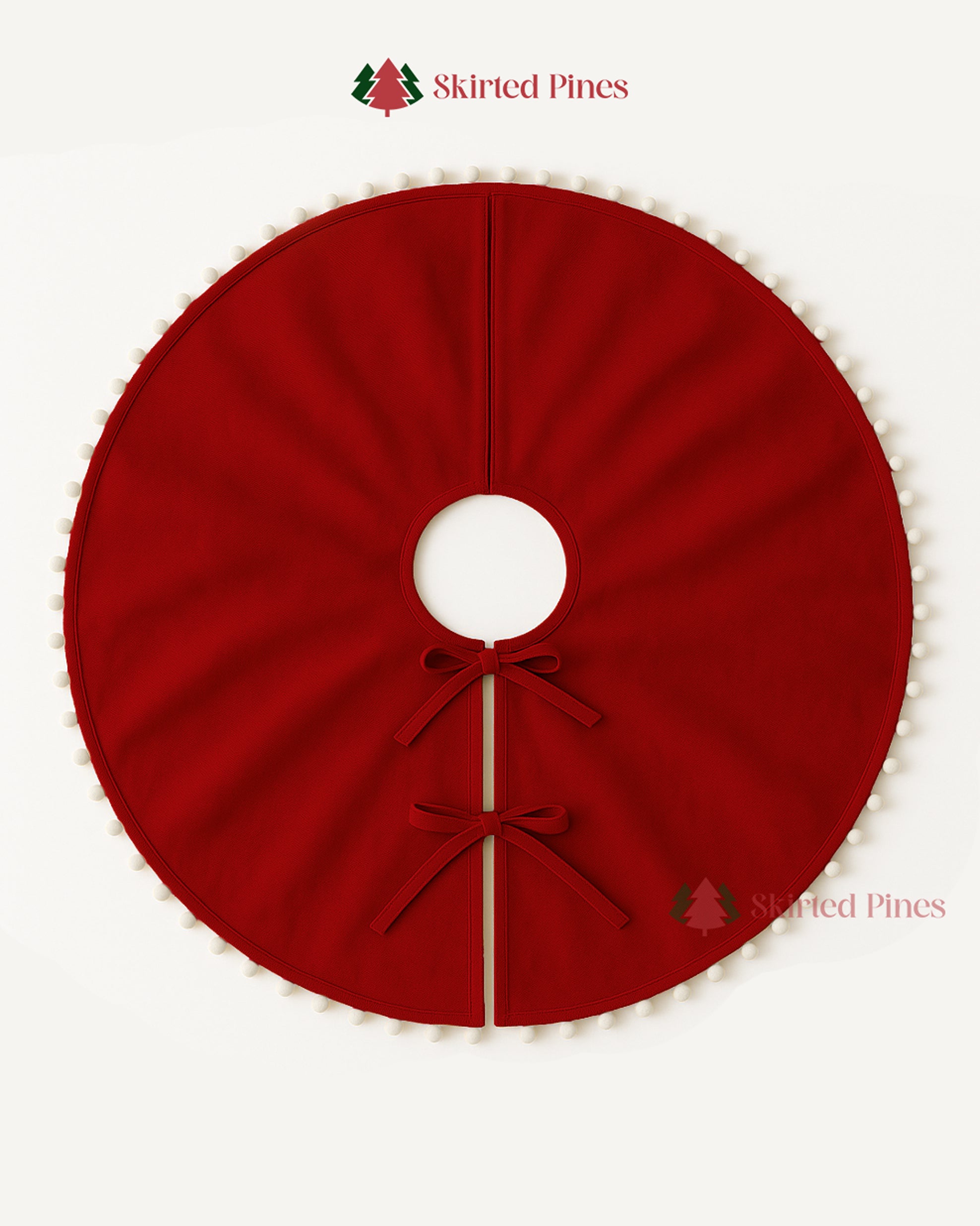 Red Christmas tree skirt with a bow on a white background, branded 'Skirted Pines'.