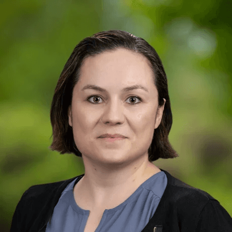 smiling woman wearing white and black pinstriped collared top