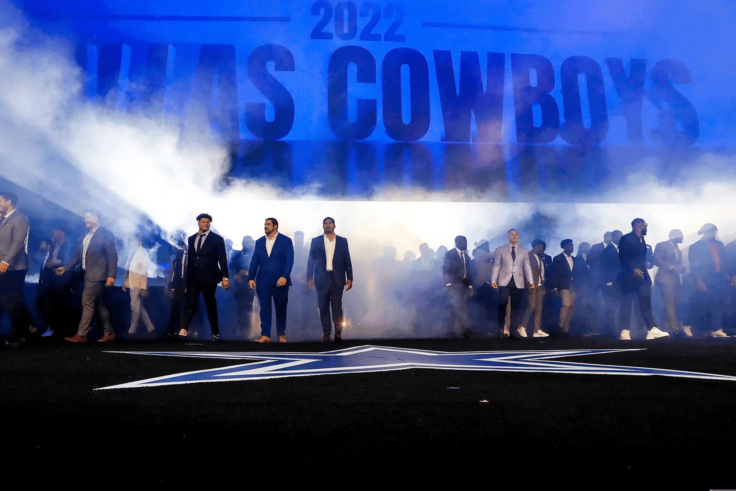 Dallas Cowboys 2022 Season Kick Off players entering the stage from a rising backdrop and smoke