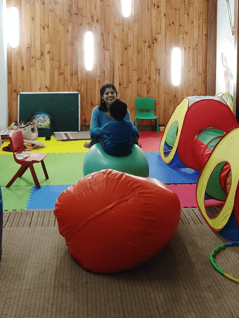Therapist guiding a child through developmental activities