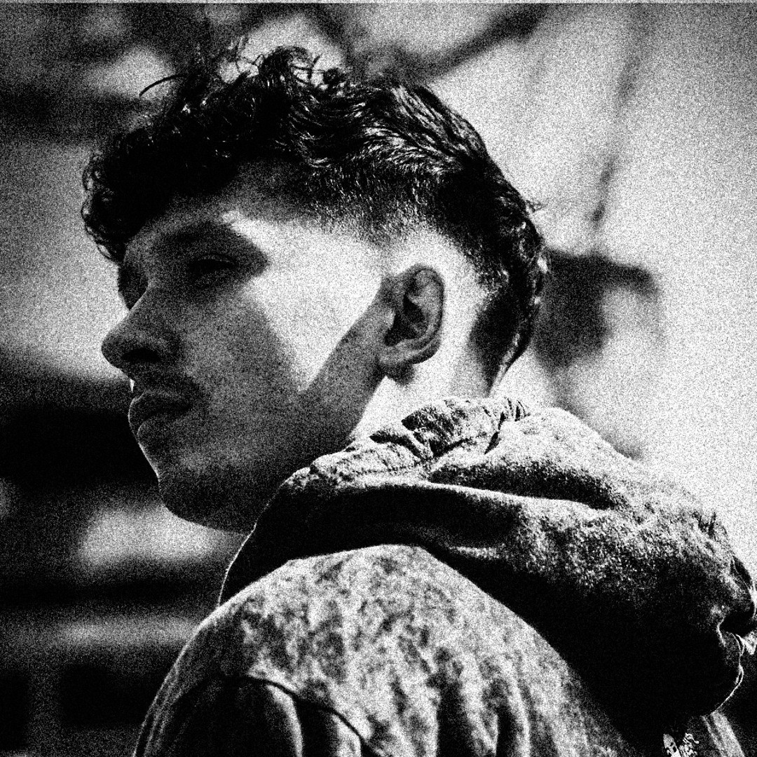 Profile portrait of a man in a grey shirt